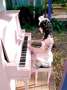 Girl In Heels And Top Hat Playing Piano